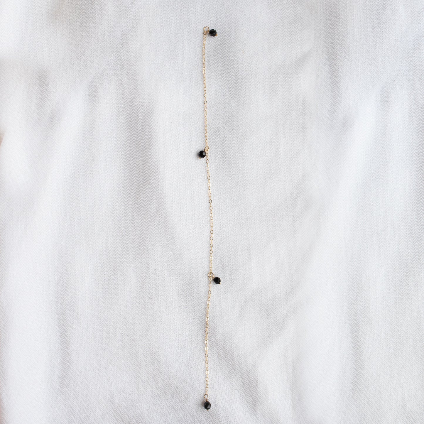 
                  
                    Onyx Droplet Back Necklace
                  
                