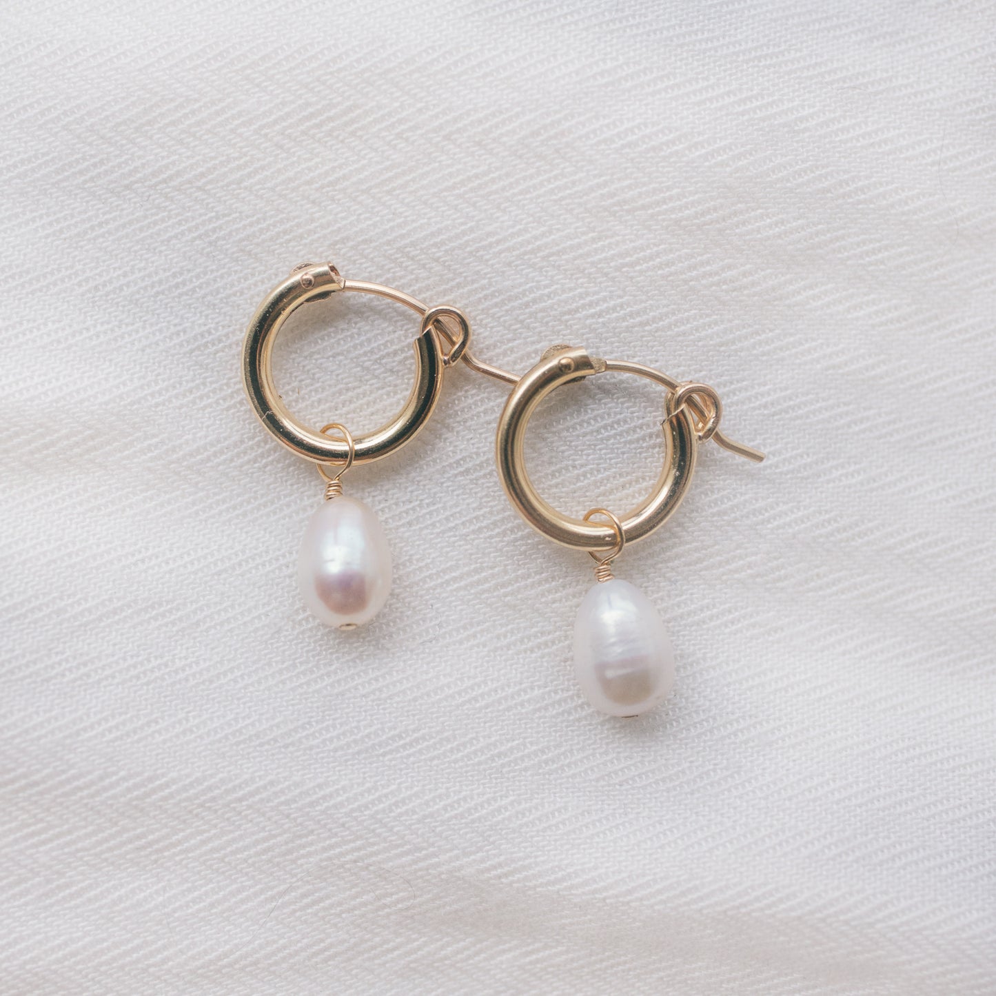 
                  
                    Oval Pearl Huggie Hoops
                  
                